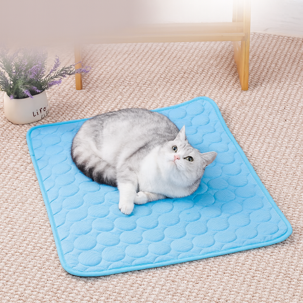 Grey cat relaxing comfortably on blue KIRE™ Ice Silk cooling mat - Self cooling pet pad for cats.